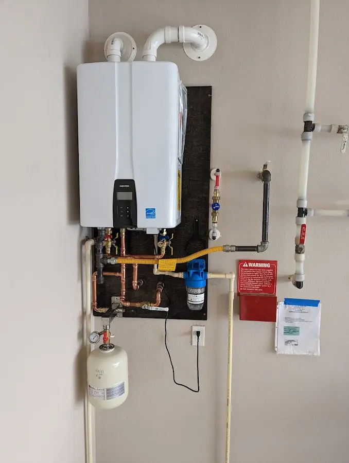 Professional plumber installing copper piping in a Eldersburg home